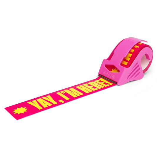 Pink packing tape with bold yellow “Yay, I’m Here!” text, shown with a matching pink dispenser—fun, colorful tape designed to make small business packages stand out and delight customers.