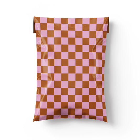 Shippy Tape poly mailer in pink and rust checkerboard design, self-sealing shipping envelope for small business packaging.