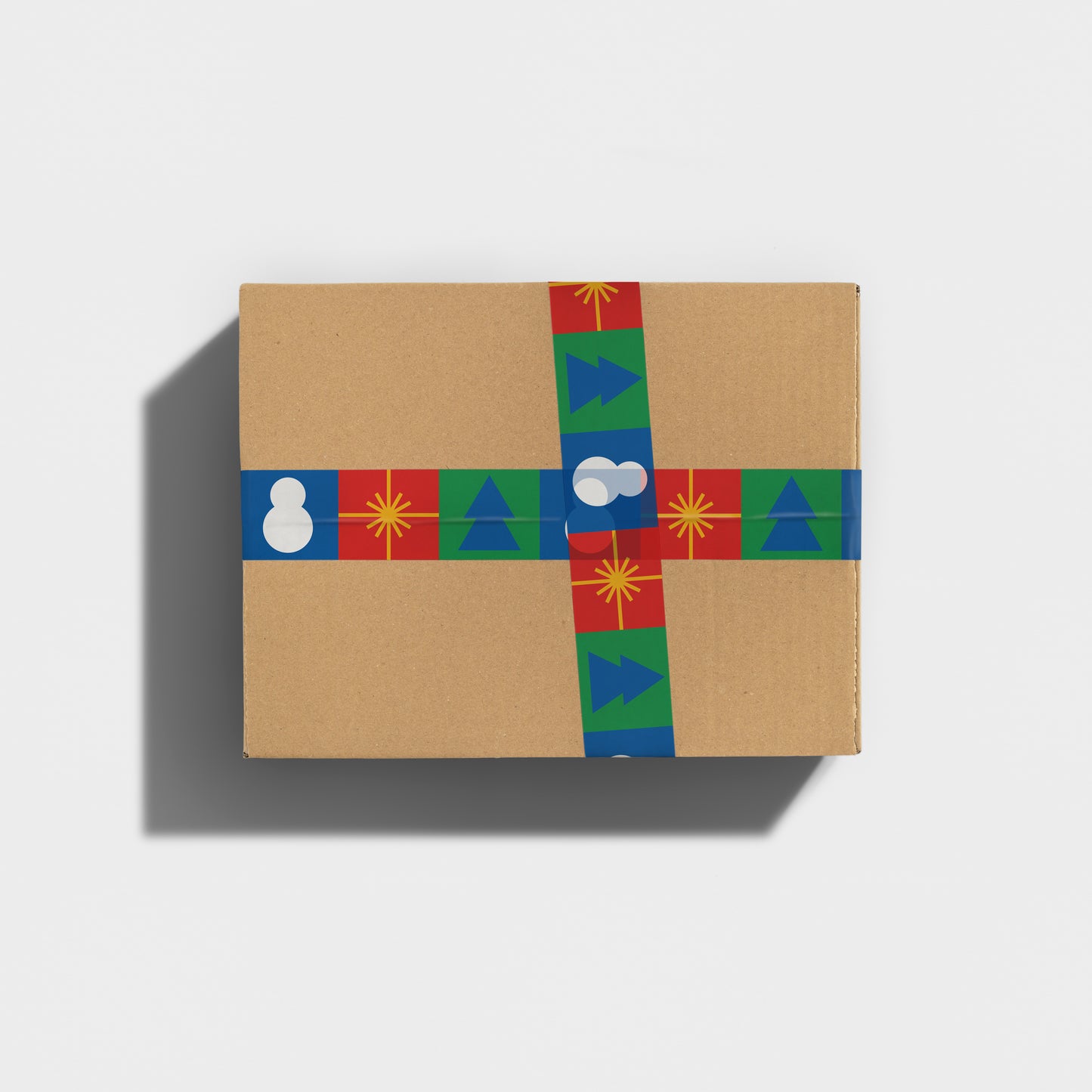 Gift-wrapped box and Christmas tree designs on sticky tape securing a parcel.