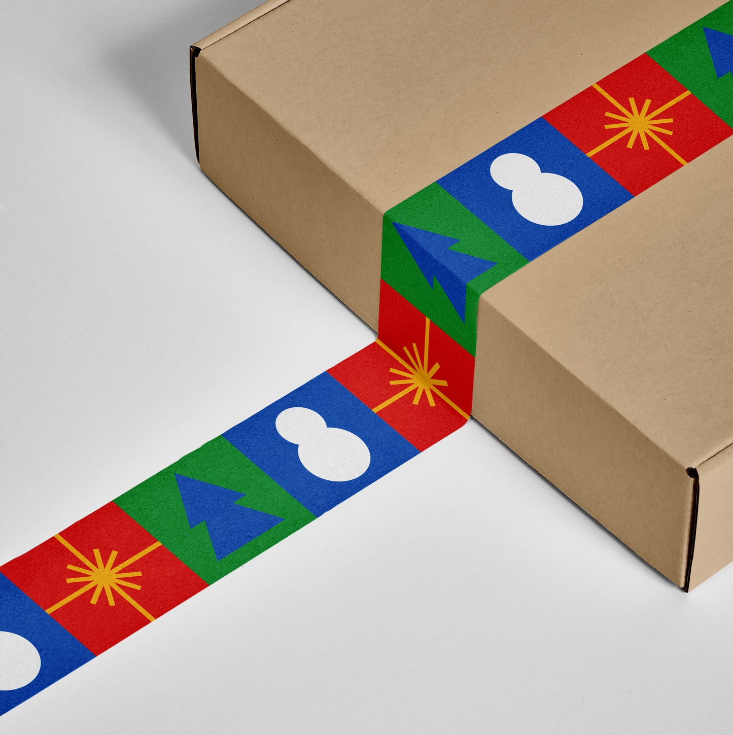 Gift-ready box secured with red, green, and gold tape, adorned with festive holiday patterns.